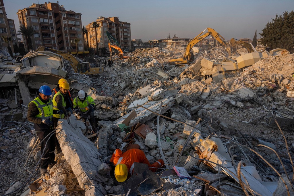 Members of a search and rescue operation work on an area that collapsed during the earthquake in Antakya, southeastern Turkey, Sunday, Feb. 12, 2023.