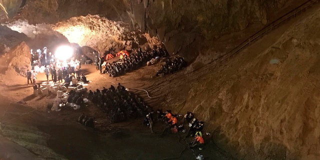 In this June 26, 2018, file photo, emergency rescue teams gather in the staging area during the cave rescue in Mae Sai, Chiang Rai province, northern Thailand.