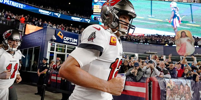 Tampa Bay Buccaneers quarterback Tom Brady runs onto the field of Gillette Stadium before playing the New England Patriots, Oct. 3, 2021, in Foxborough, Massachusetts.