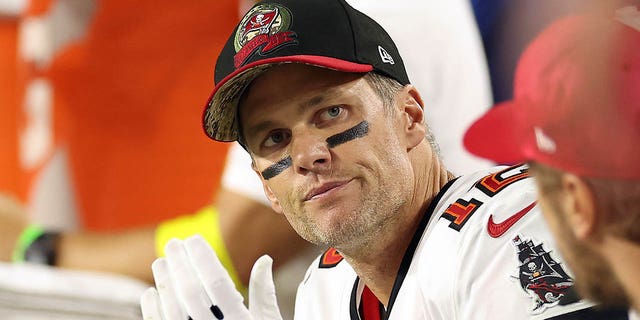 Tom Brady, #12 of the Tampa Bay Buccaneers, reacts on the bench during the 4th quarter  of the game against the Arizona Cardinals at State Farm Stadium on Dec. 25, 2022 in Glendale, Arizona.