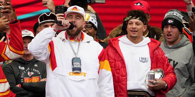 Travis Kelce #87 and Patrick Mahomes #15 of the Kansas City Chiefs celebrate on stage during the Kansas City Chiefs Super Bowl LVII victory parade on February 15, 2023 in Kansas City, Missouri.