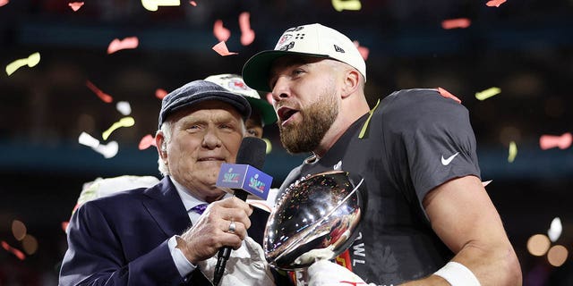 Travis Kelce #87 of the Kansas City Chiefs celebrates with the the Vince Lombardi Trophy after defeating the Philadelphia Eagles 38-35 in Super Bowl LVII at State Farm Stadium on February 12, 2023 in Glendale, Arizona.