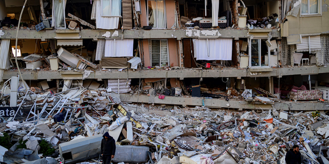 A man walks among the rubble of a collapsed building in Hatay, Turkey, on Friday, Feb. 10.