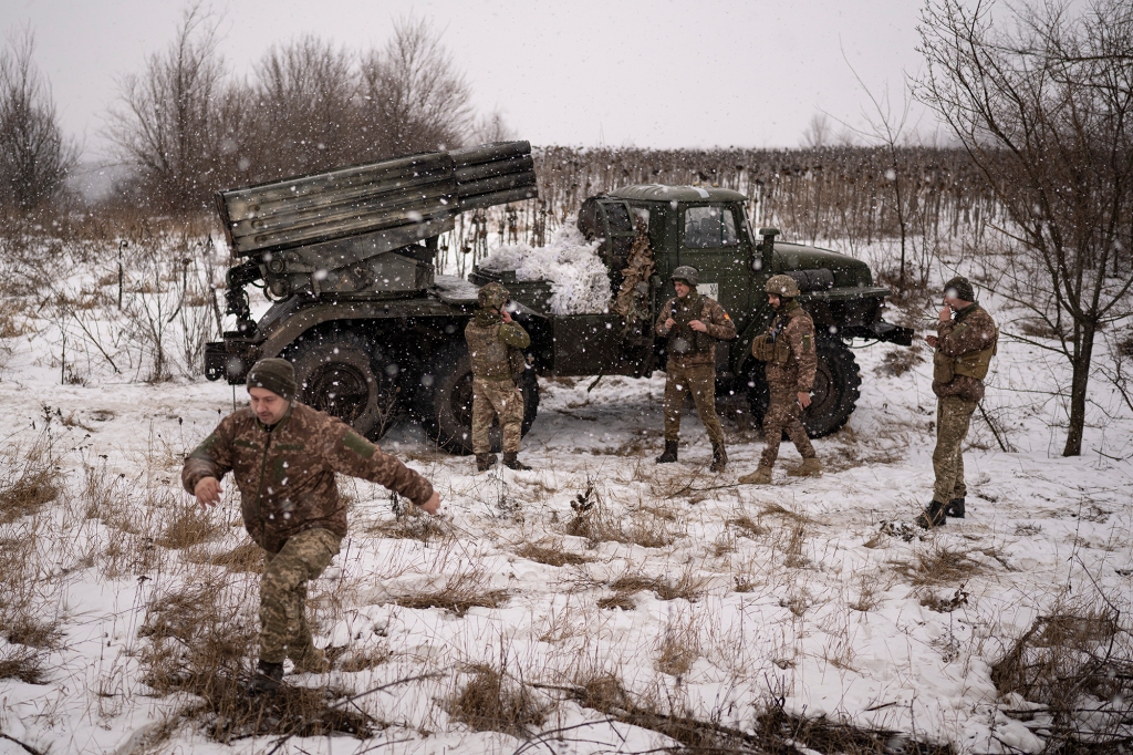 Ukrainian servicemen of the Prince Roman the Great 14th Separate Mechanized Brigade stand around a Soviet era Grad multiple rocket launcher before firing at Russian positions in the Kharkiv area, Ukraine, Saturday, Feb. 25, 2023.