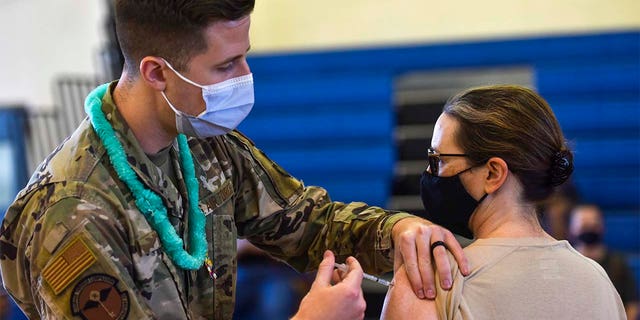 In this Feb. 9, 2021 photo provided by the Department of Defense, Hickam 15th Medical Group host the first COVID-19 mass vaccination on Joint Base Pearl Harbor-Hickam. By the thousands, U.S. service members are refusing or putting off the COVID-19 vaccine, as frustrated commanders scramble to knock down internet rumors and find the right pitch that will convince troops to take the shot. Some Army units are seeing as few as a third agree to the vaccine, others are higher. (U.S. Air Force Tech. Sgt. Anthony Nelson Jr./Department of Defense via AP)