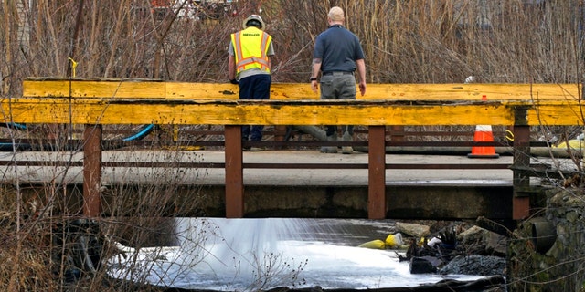 HEPACO workers, an environmental and emergency services company, observe a stream in East Palestine, Ohio, Thursday, Feb. 9, 2023 as the cleanup continues after the derailment of a Norfolk Southern freight train on Feb. 3. 