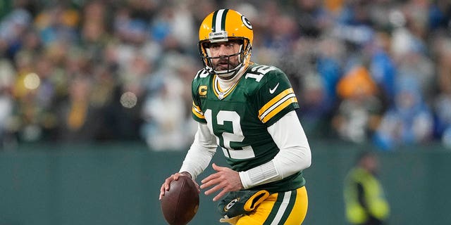 Aaron Rodgers #12 of the Green Bay Packers looks to throw a pass against the Detroit Lions in the first half at Lambeau Field on January 08, 2023 in Green Bay, Wisconsin.