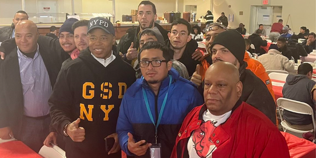 New York City Mayor Eric Adams poses for photo at the Brooklyn Cruise Terminal.