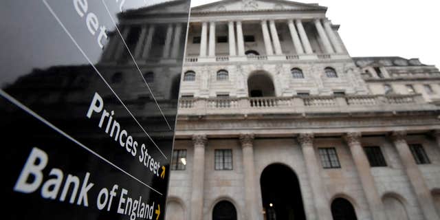 The Bank of England building is reflected in a sign, London, Britain, on Dec. 16, 2021. 