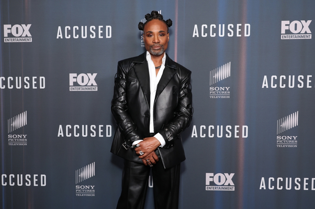 Billy Porter wearing a suit posing for a photo. 