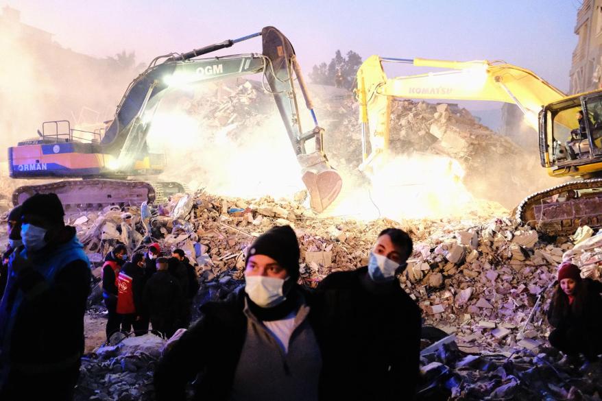 Trucks dig through rubble of earthquake