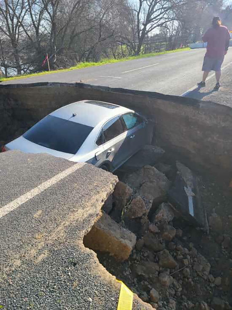 Five days earlier, a Volkswagen sedan crashed into the same sinkhole after its owner disregarded warning signs. 