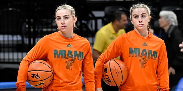 Haley Cavinder, left, and Hanna Cavinder of the Miami Hurricanes warm up before a game against the Pittsburgh Panthers at Petersen Events Center Jan. 1, 2023, in Pittsburgh. 