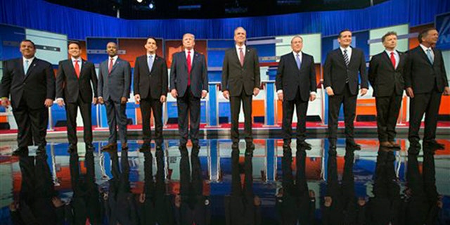 Republican presidential candidates in the 2016 cycle, from left, Chris Christie, Marco Rubio, Ben Carson, Scott Walker, Donald Trump, Jeb Bush, Mike Huckabee, Ted Cruz, Rand Paul, and John Kasich take the stage for the first Republican presidential debate in Cleveland, Ohio, on August 6, 2015. (AP Photo/Andrew Harnik, File)
