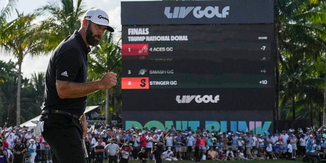 Dustin Johnson pumps his fist after sinking the winning putt during the team championship stroke-play round of the LIV Golf Invitational - Miami on Oct. 30, 2022c, in Doral, Florida.