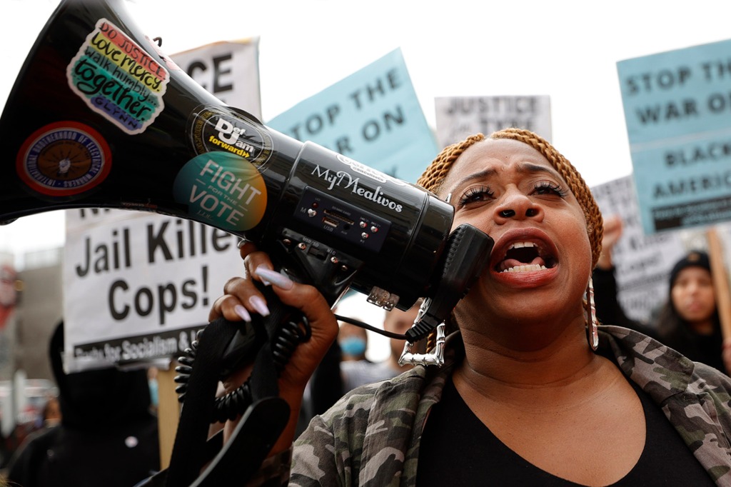 Porchse Miller yells through a bullhorn during a protest, Saturday, Jan. 28, 2023, in Atlanta, over the death of Tyre Nichols, 