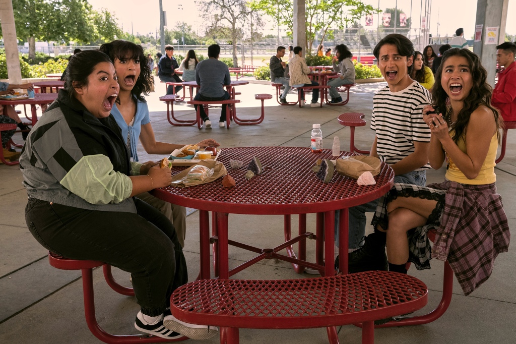 Gloria (Keyla Monterosso Mejia), Ines (Bryana Salaz), Cameron (Tenzing Norgay Trainor) and Demi (Ciara Riley Wilson). They're sitting outside at round lunch table at school and they're all screaming.