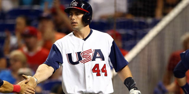 Ian Kinsler of Team USA is greeted by teammate Paul Goldschmidt after scoring a run during Game 6 of Pool C of the 2017 World Baseball Classic against Team Canada March 12, 2017, at Marlins Park in Miami, Fla. 