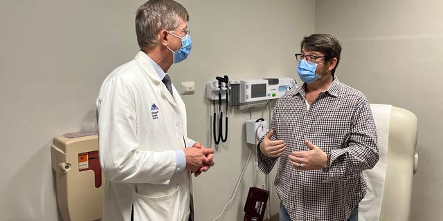 Dr. John Puskas (left) and patient David Holland, who underwent a unique type of quadruple bypass surgery in November 2022. 