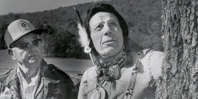 Garth, Alabama: Keep American Beautiful Spokesman Iron Eyes Cody, (right), inspects the hardwood trees on Yancy Clemons' 700 acre "Treasure Forest" in northeastern Alabama's Paint Rock Valley in 1984.