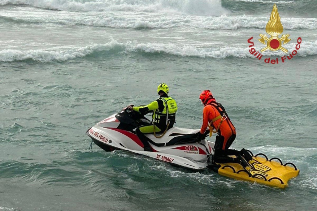 Rescue crews ride a jet ski in the choppy waters of southern Italy after a migrant shipwreck