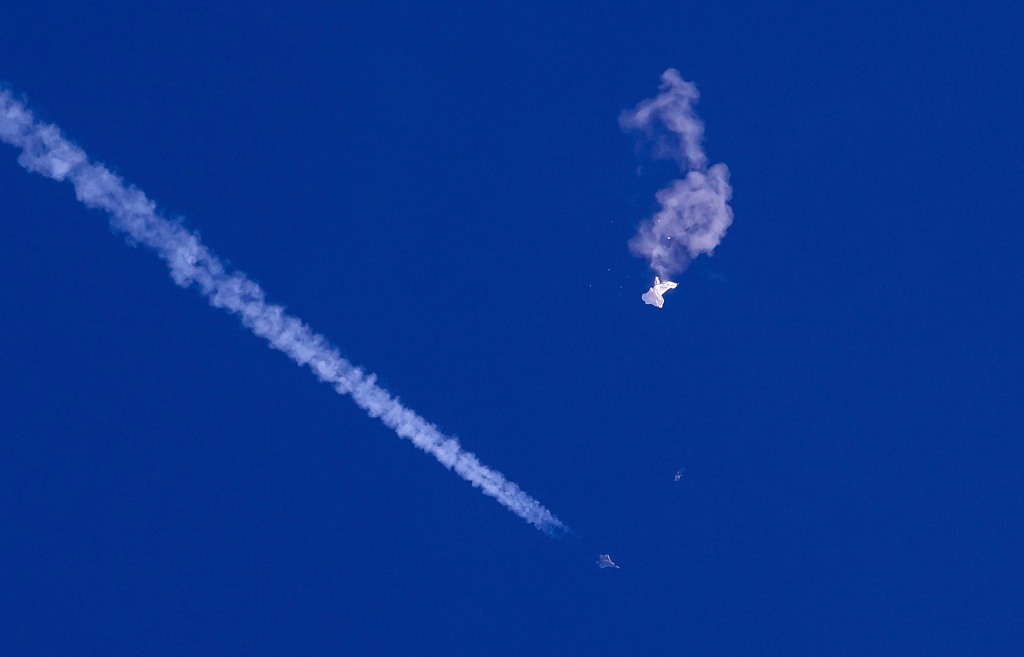 Remnants of a Chinese spy balloon fall from the sky after US fighter jets hit it with a missile on Feb. 4 off South Carolina. 