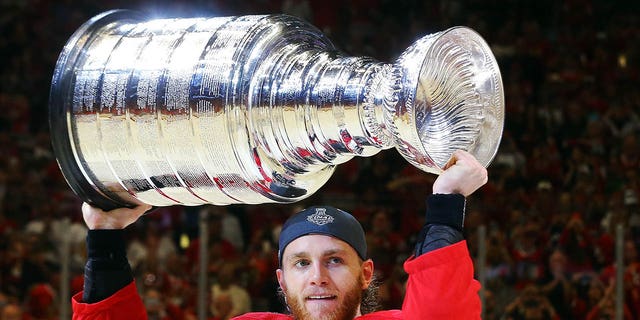 Patrick Kane of the Chicago Blackhawks celebrates by hoisting the Stanley Cup after defeating the Tampa Bay Lightning 2-0 in Game 6 to win the 2015 NHL Stanley Cup Final at the United Center June 15, 2015, in Chicago.  