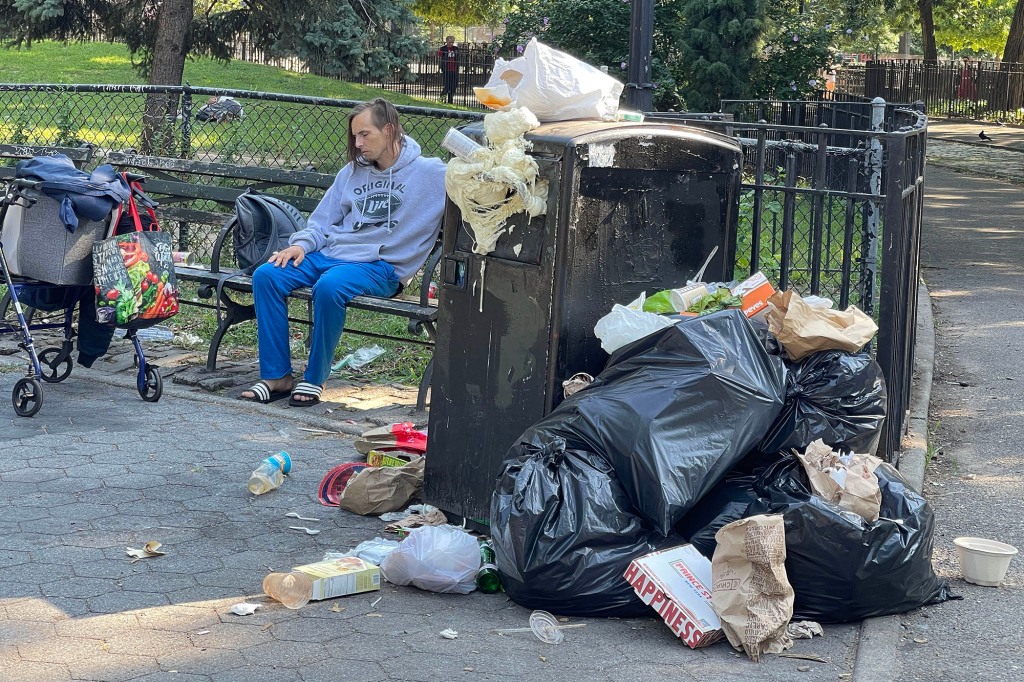 Garbage overflowing at trash receptacle in Tompkins Square Park.