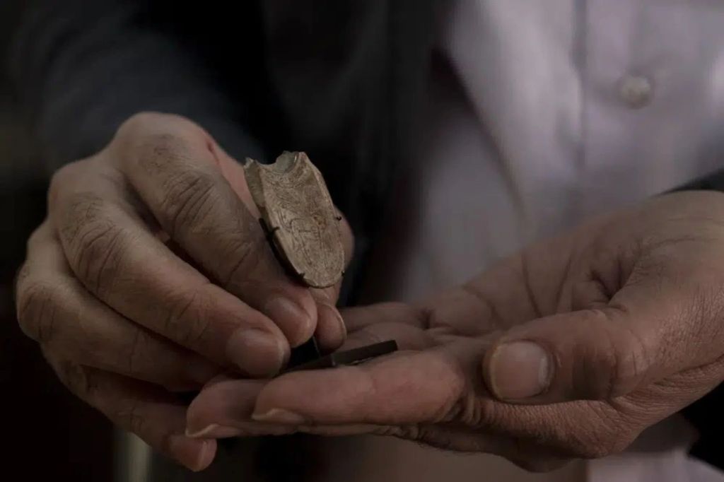 Jihad Yassin holds a 2,700 year-old incense spoon with ornate engravings. 