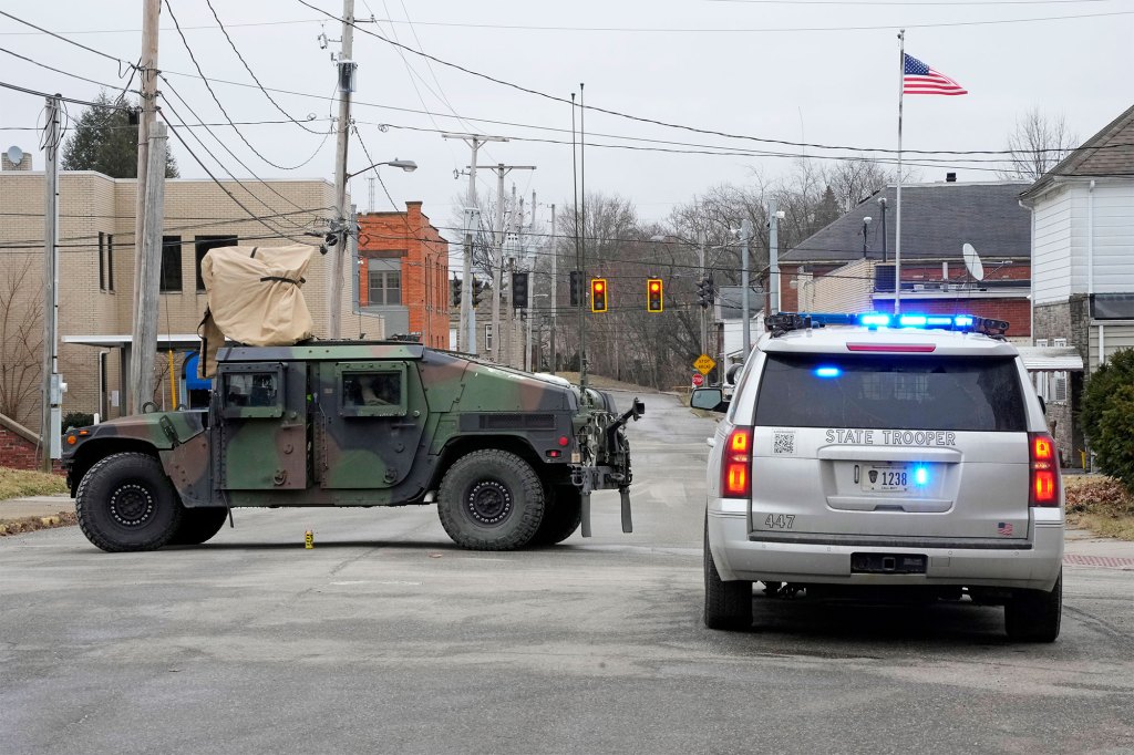 A road in East Palestine, Ohio, is blocked after residents within a one-mile radius surrounding the site were ordered to evacuate. 