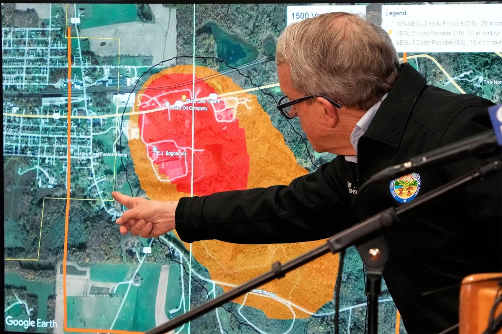 Ohio Governor Mike DeWine points to a map during a news conference Monday. 