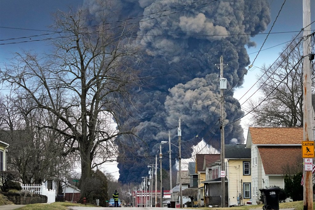 A black plume rises over East Palestine, Ohio, as a result of the controlled detonation of a portion of the derailed Norfolk and Southern trains on Monday.