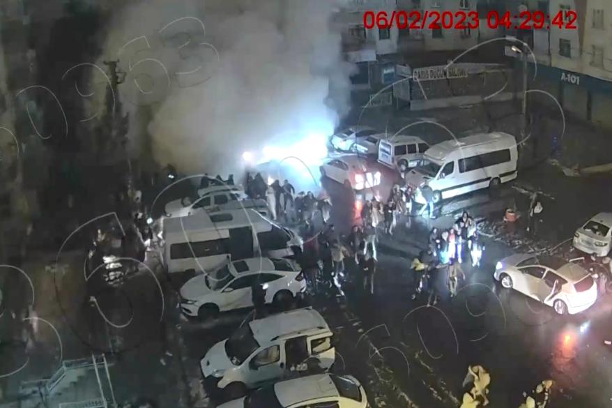 A screen grab shows people running from falling buildings in Turkey.