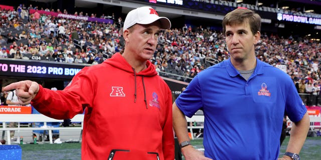 NFC head coach Eli Manning, right, and AFC head coach Peyton Manning talk during the 2023 NFL Pro Bowl Games at Allegiant Stadium on Feb. 5, 2023, in Las Vegas.