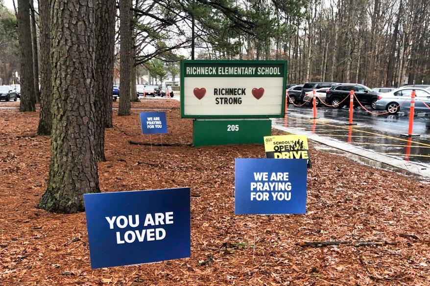 Signs stand outside Richneck Elementary School in Newport News.