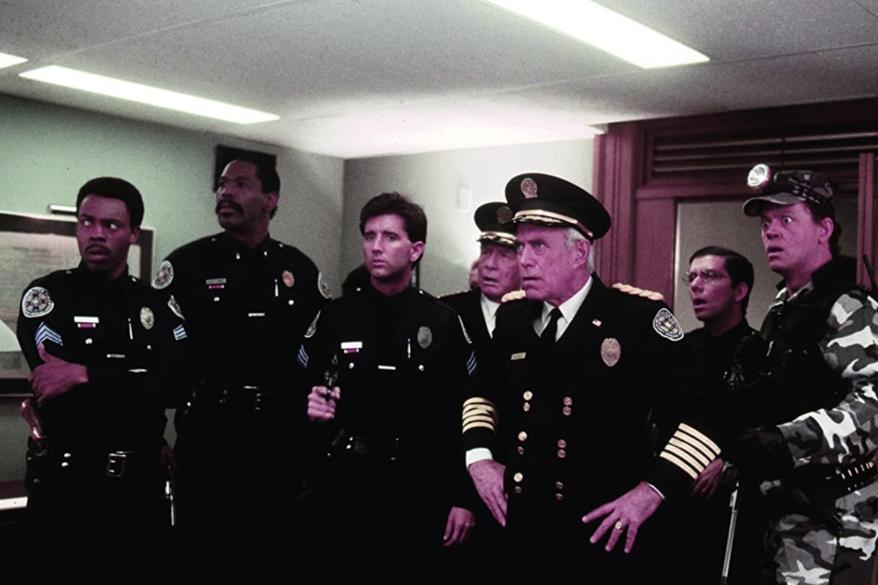 George Gaynes, David Graf, Bruce Mahler, Matt McCoy, George R. Robertson, with his hands on his hips, Bubba Smith and Michael Winslow appeared in "Police Academy 6: City Under Siege" in 1989.