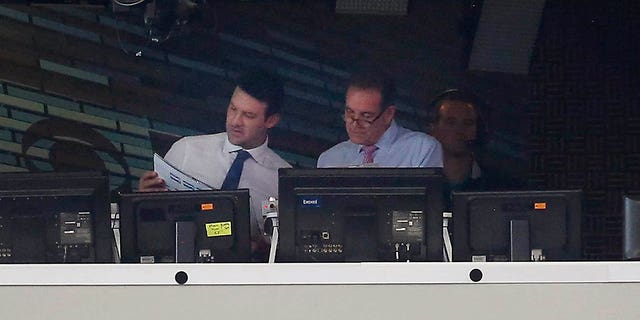 Former Dallas Cowboys quarterback and CBS commentator Tony Romo, left, talks with play-by-play announcer Jim Nantz before the first half of a game between the Cowboys and Kansas City Chiefs Nov. 5, 2017, in Arlington, Texas. 