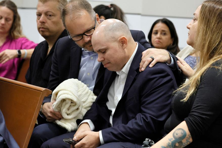 Ryan Petty comforts Ilan Alhadeff as they await the verdict in the trial of Marjory Stoneman Douglas High School shooter Nikolas Cruz.