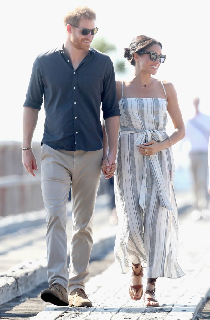 Prince Harry and Meghan walk along Kingfisher Bay Jetty in Australia on Oct. 22, 2018.