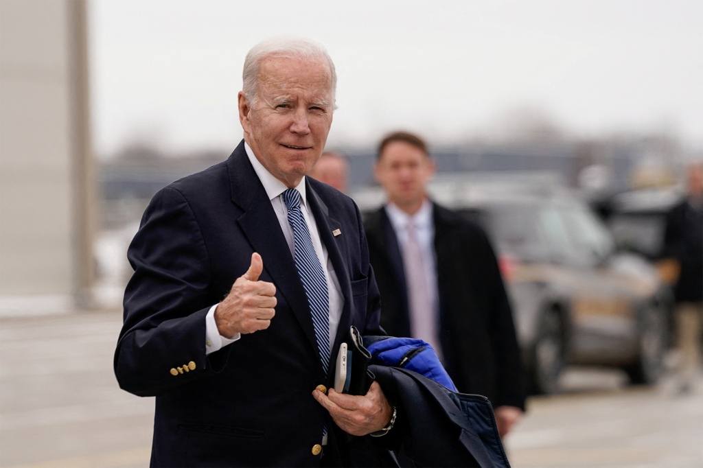 U.S. President Joe Biden gestures to reporters before boarding Air Force One.