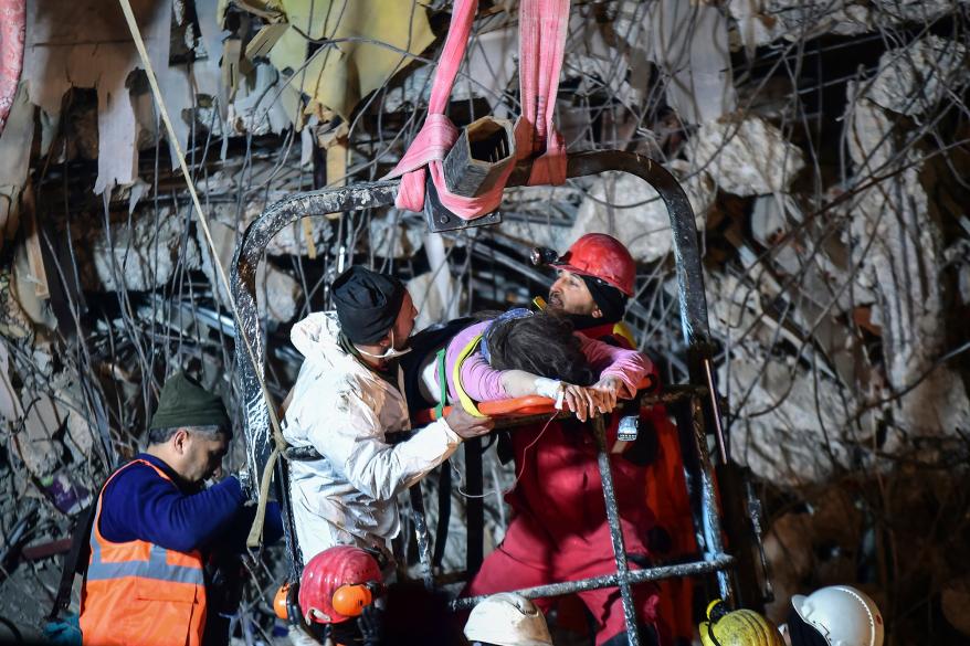 Rescuers pull out a woman from a collapsed building 87 hours after the earthquake in Kahramanmaras, southern Turkey, Thursday, Feb. 9, 2023.