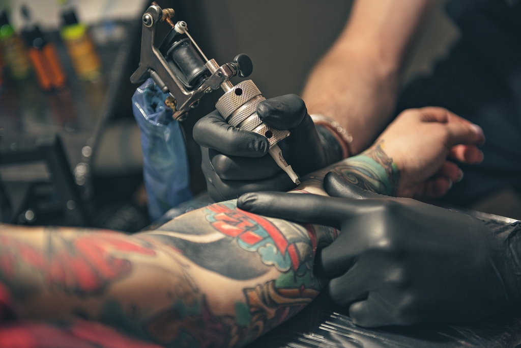 Tattoo artist with tattoo needle