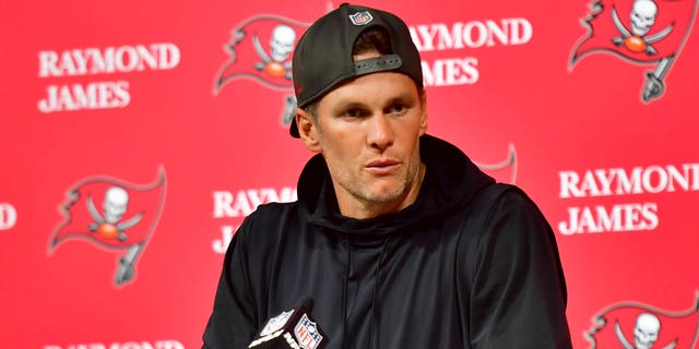 Tom Brady #12 of the Tampa Bay Buccaneers speaks to the media after losing to the Dallas Cowboys 31-14 in the NFC Wild Card playoff game at Raymond James Stadium on January 16, 2023 in Tampa, Florida. 