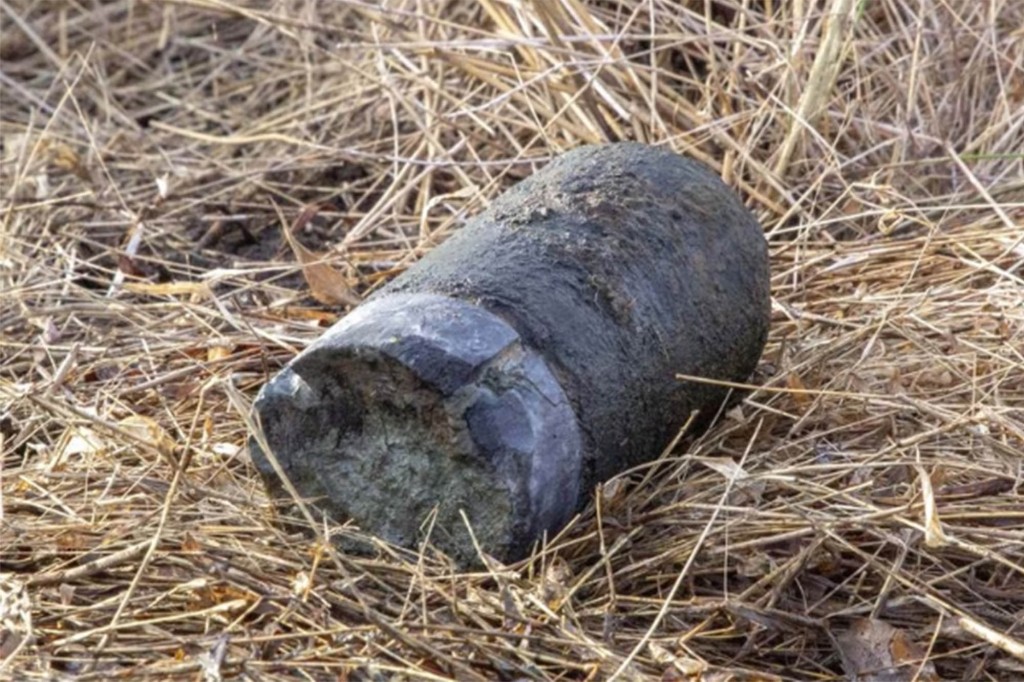 The Civil War artillery shell found at Gettysburg last week lies on the grass.