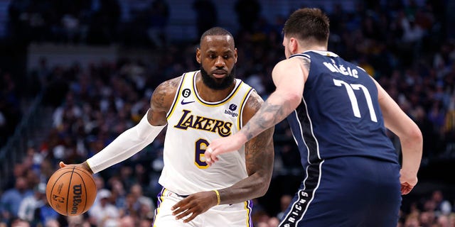 LeBron James (6) of the Los Angeles Lakers handles the ball as Luka Doncic (77) of the Dallas Mavericks defends in the second half at American Airlines Center Feb. 26, 2023, in Dallas, Texas. The Lakers won 111-108.