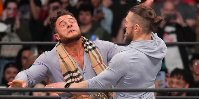 Feb 22, 2023; Phoenix, AZ, USA; AEW Champion Maxwell Jacob Friedman aka MJF  (suit) and Bryan Danielson (hoodie) during AEW Dynamite at Footprint Center. 