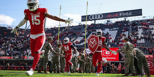 The D.C. Defenders take the field before the XFL game against the St Louis BattleHawks at Audi Field on March 5, 2023, in Washington, D.C.