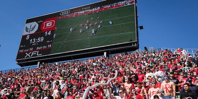 Fans celebrate during the XFL game between the Defenders and the BattleHawks at Audi Field on March 5, 2023, in Washington, D.C.