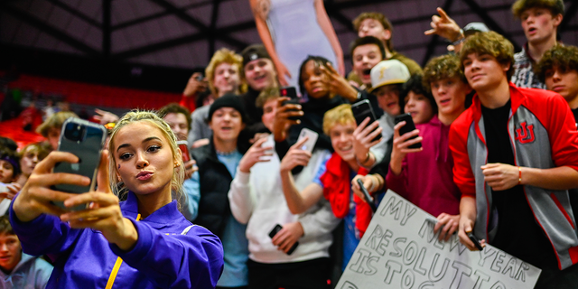 Olivia Dunne of LSU takes a 'selfie' with fans after a PAC-12 meet against Utah at Jon M. Huntsman Center on January 06, 2023 in Salt Lake City, Utah.