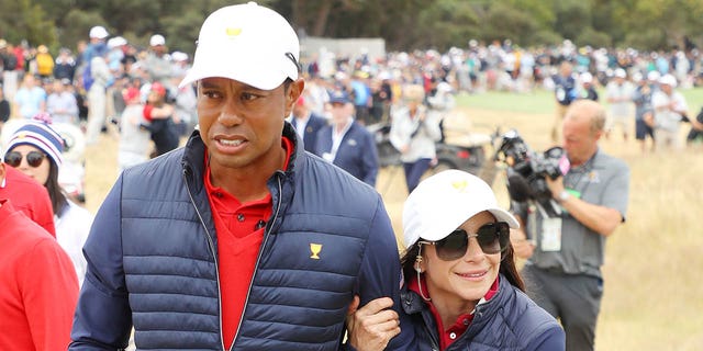 Tiger Woods of the United States and girlfriend Erica Herman celebrate after winning the Presidents Cup 16-14 Dec. 15, 2019, in Melbourne, Australia.